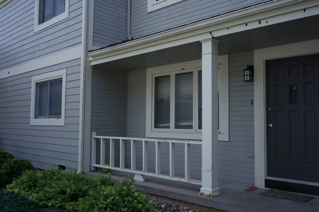 Apartment entry and porch with the original siding still in place