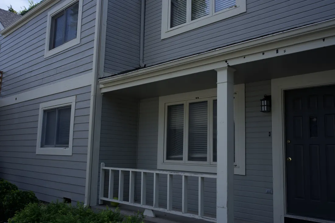 Covered entry porch and the original siding before the replacement
