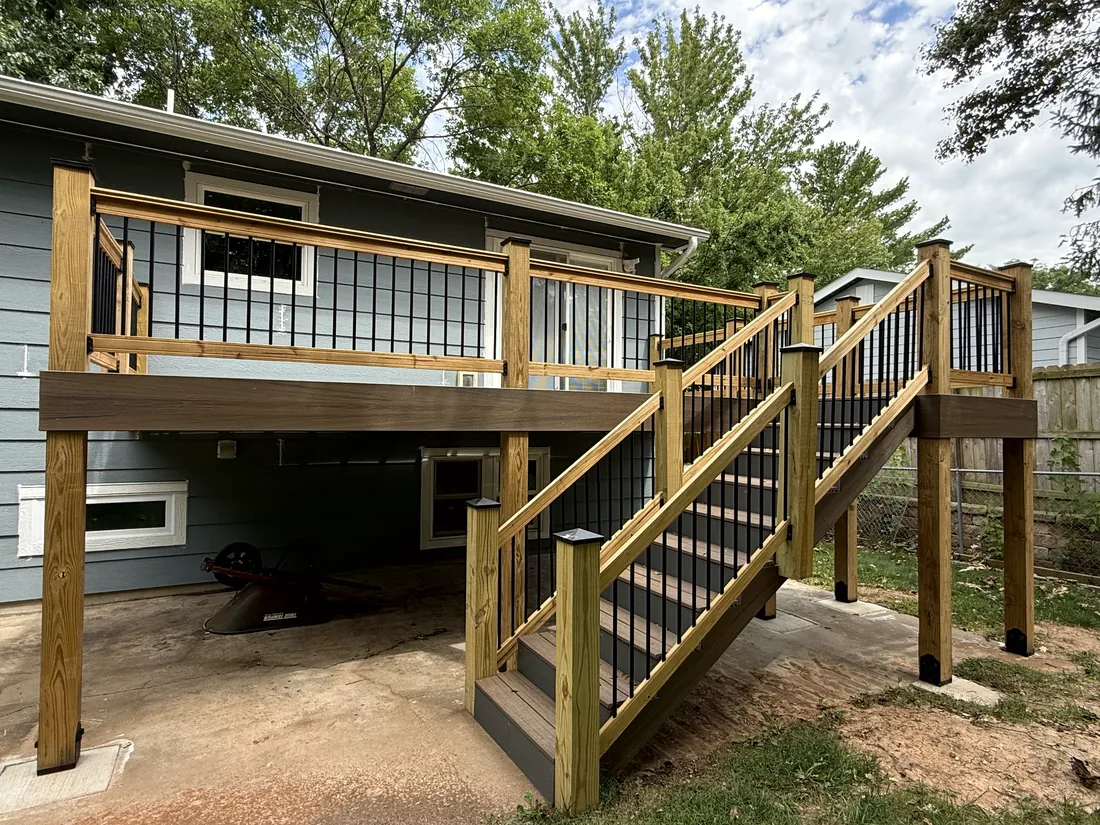 Cedar top rail and black metal balusters on a finished elevated deck