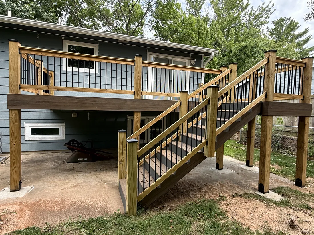 Elevated deck with cedar railings, black balusters and a composite stair run