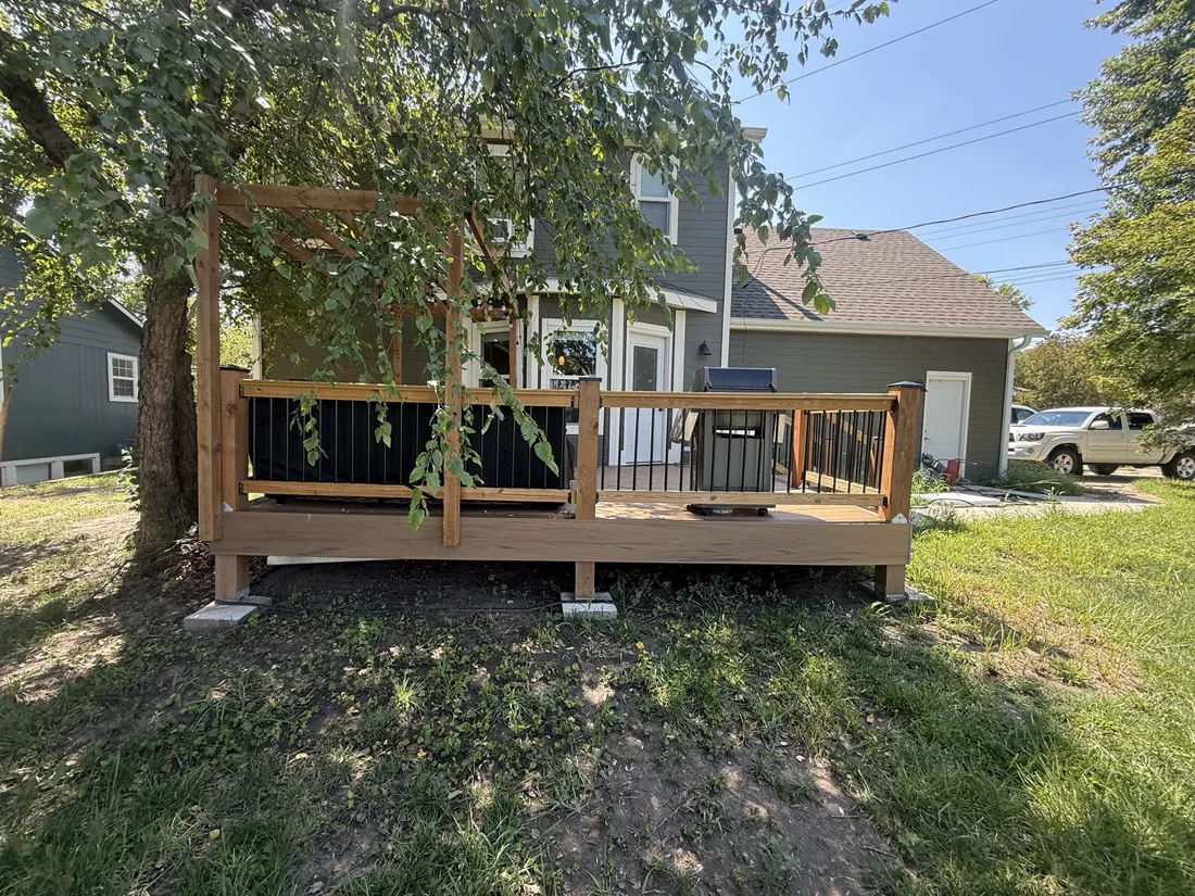 Finished deck and railing seen across the back yard