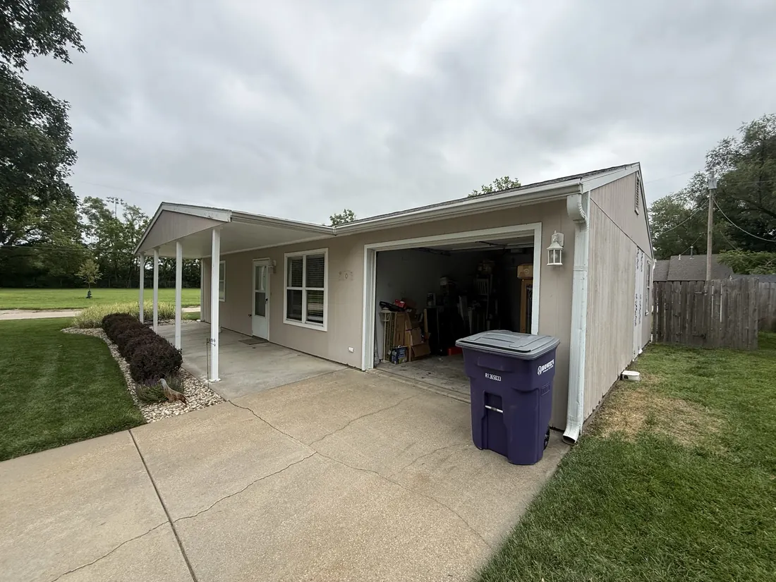Driveway elevation and carport before the siding replacement