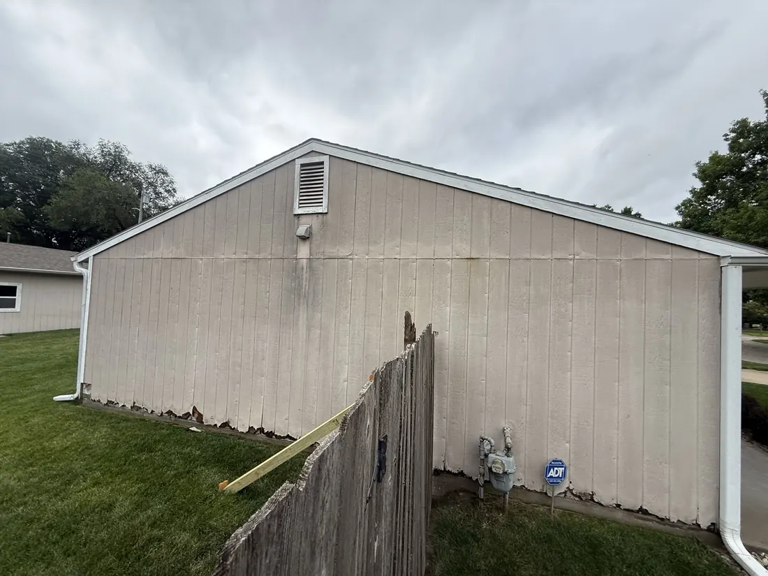 Weathered end wall and gutter line before new siding was fitted