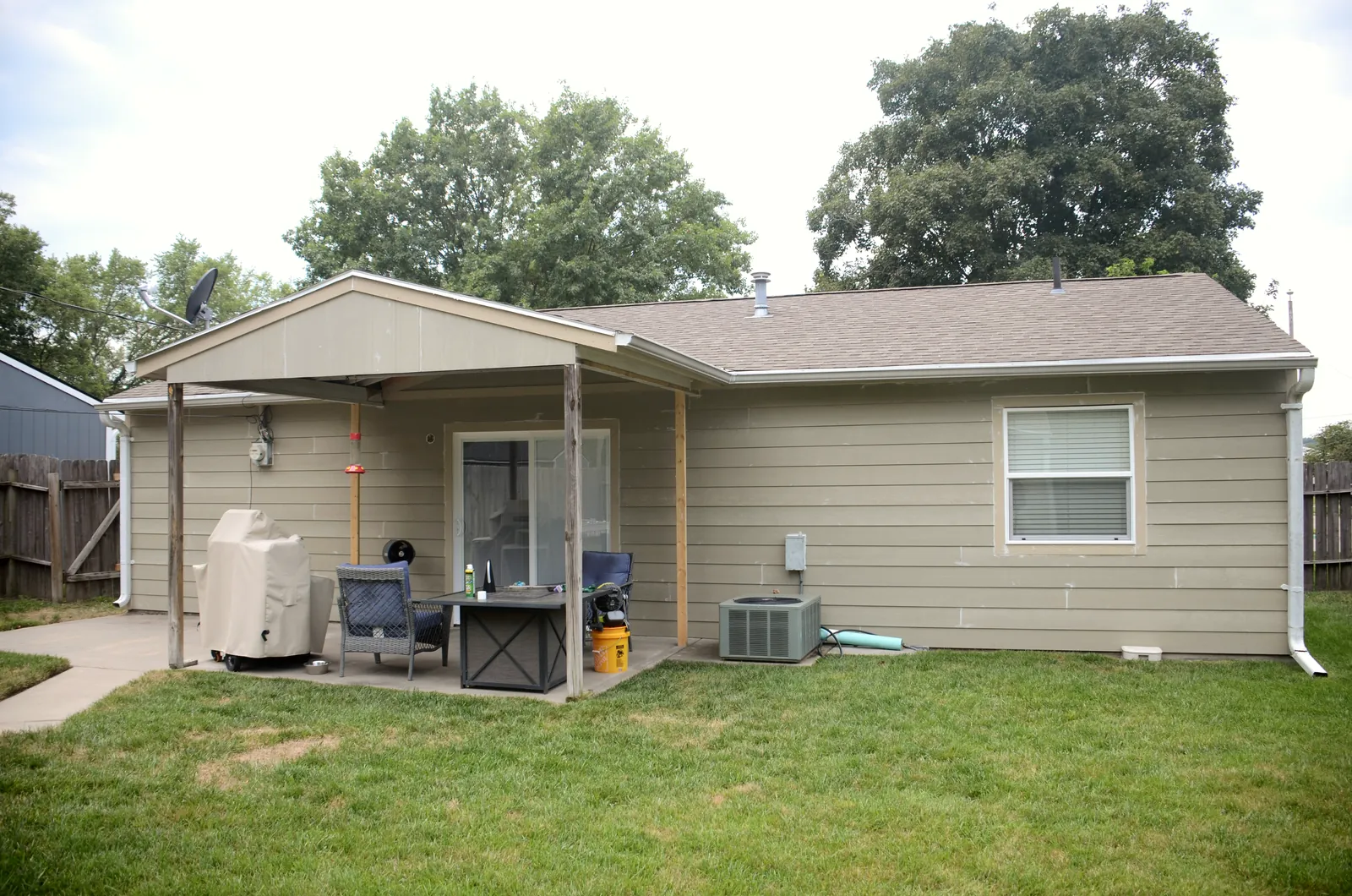 Full rear elevation of the same home after a complete siding replacement