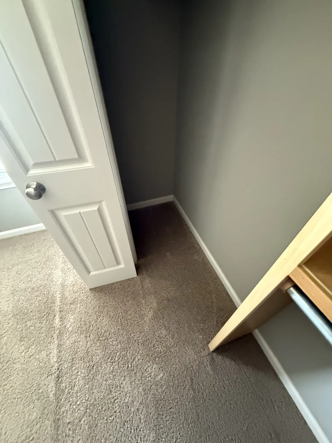 New carpet laid through a bedroom and into its closet