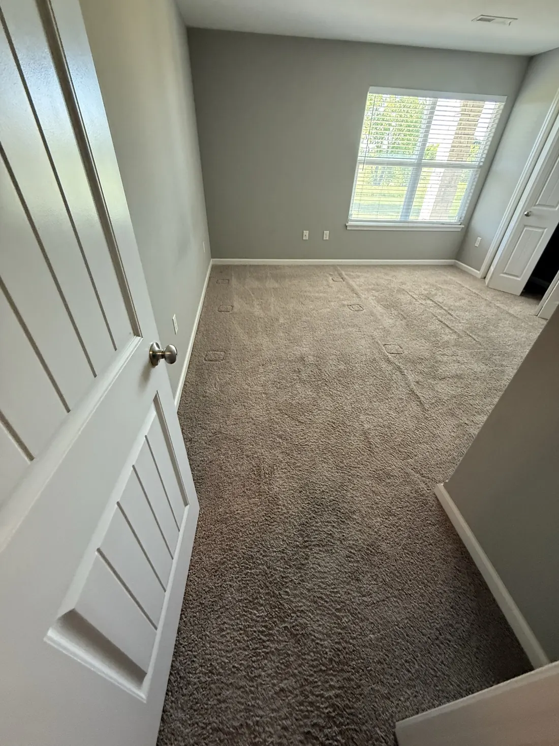 New carpet finished cleanly at a bedroom doorway