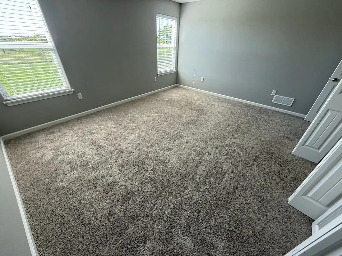 Bedroom finished in soft grey carpet with white trim