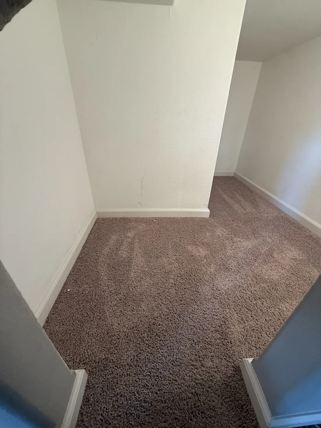 New carpet laid across a landing and into the hall