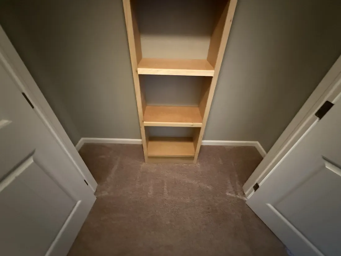 Carpet carried into a shelved linen closet