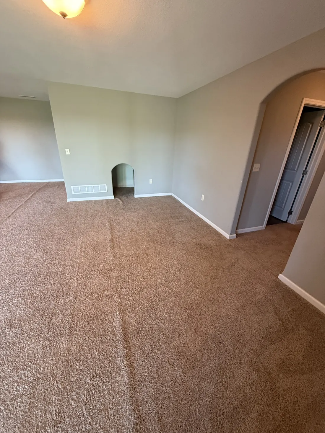 New carpet turning the corner at the foot of a stair run