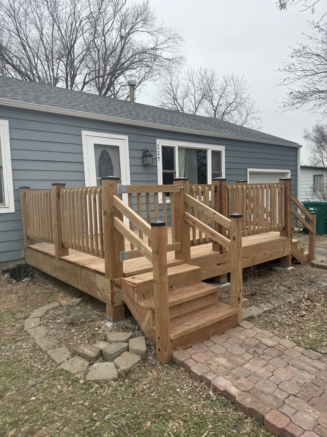 Newly built cedar deck, railings and steps on a grey clad home