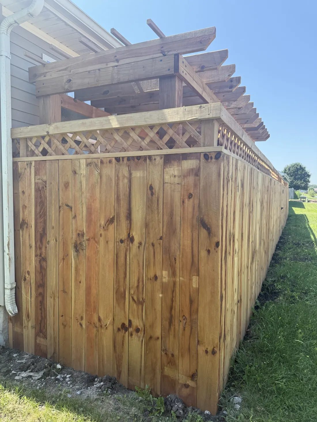 End post and lattice top on a new cedar fence