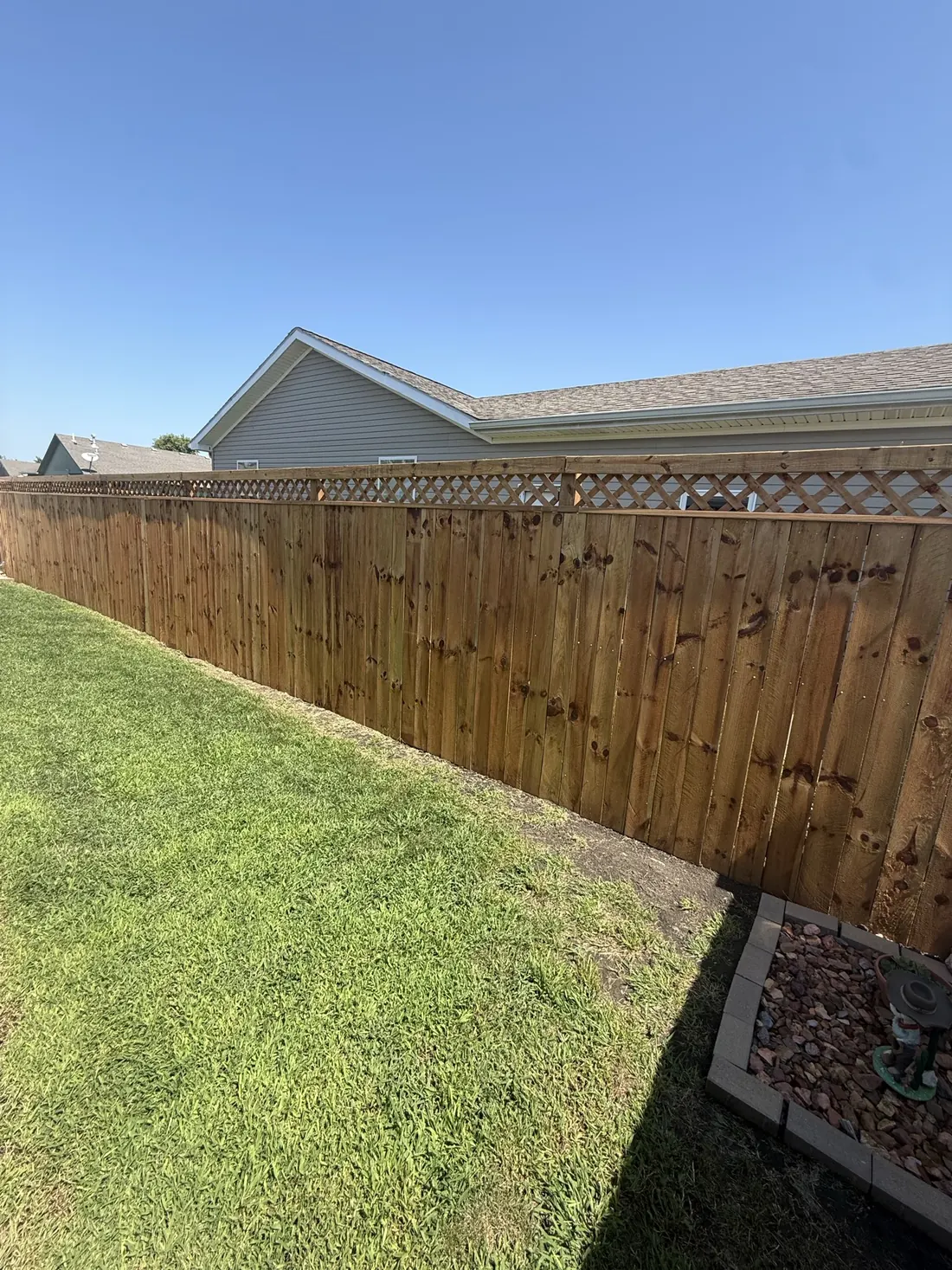 Cedar fence meeting the corner of the house