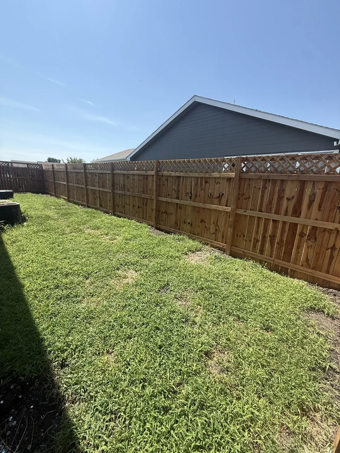 Lattice topper finishing the run of a new cedar privacy fence