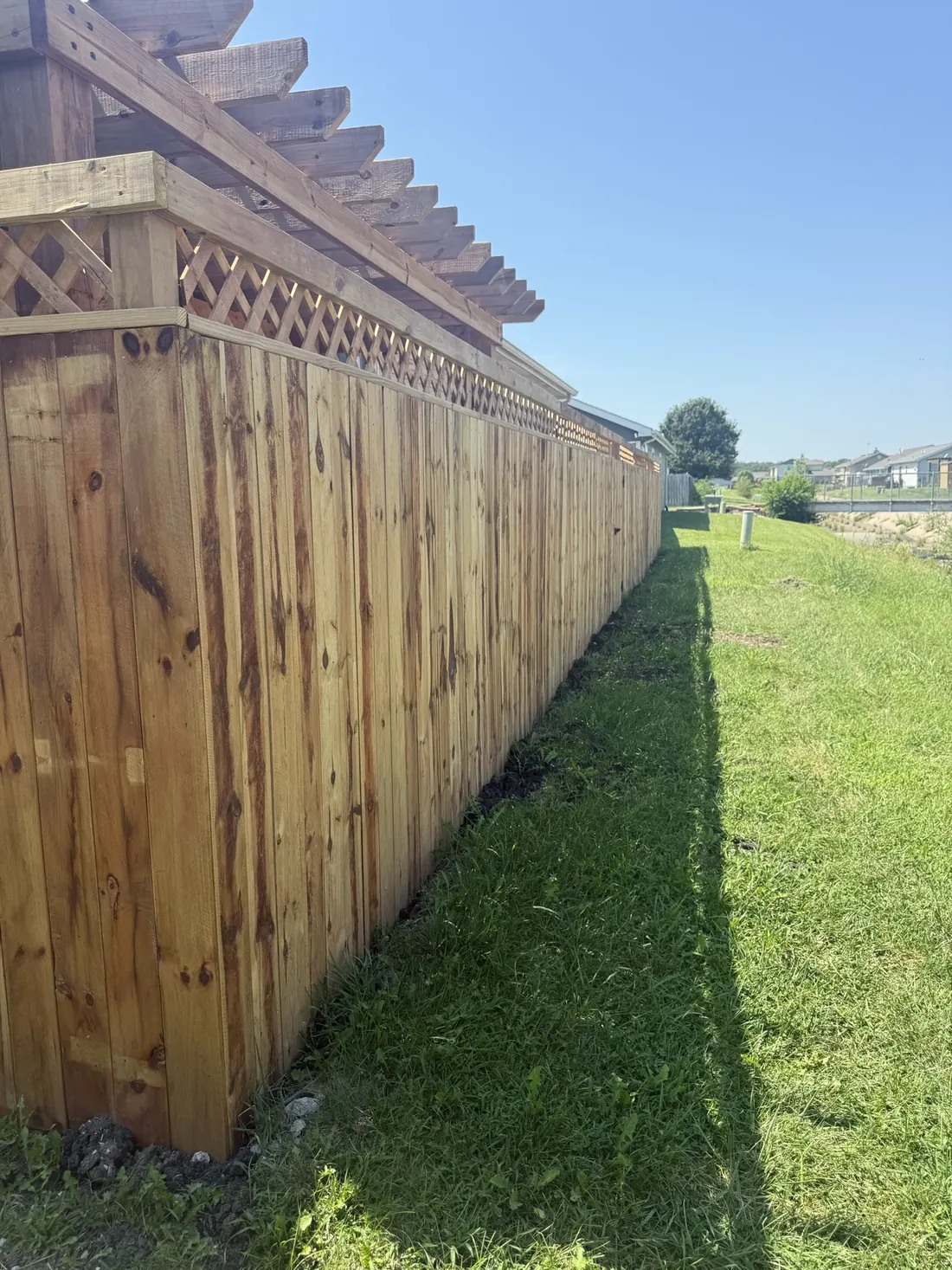 Long run of new cedar privacy fence along a back yard