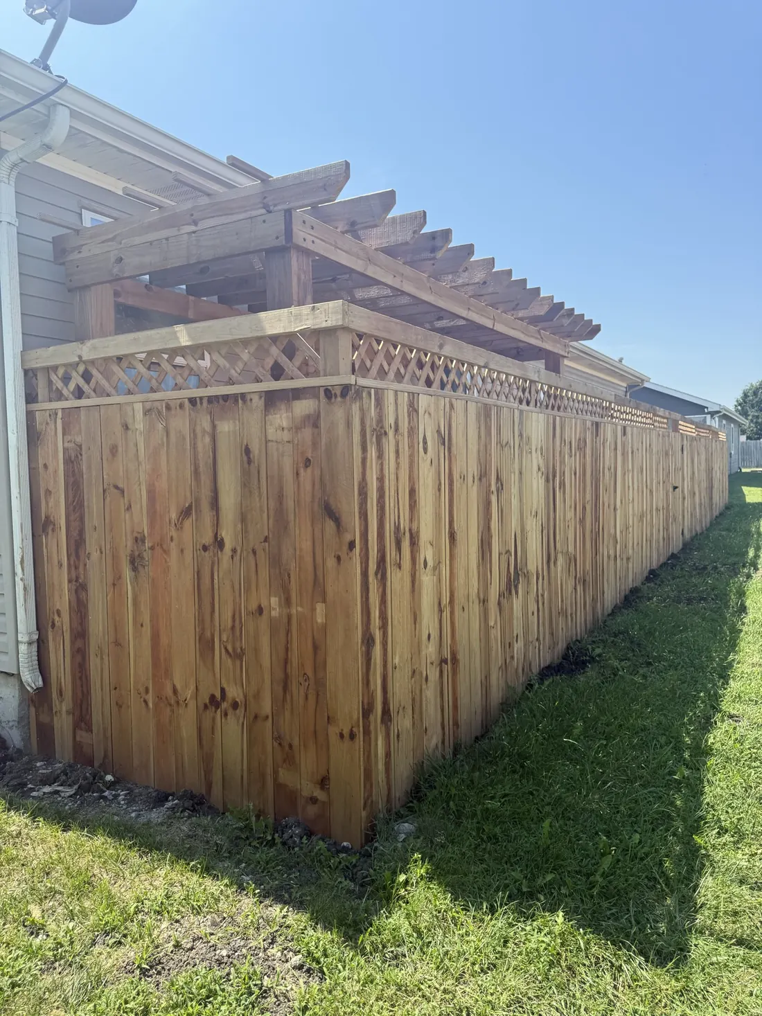 Cedar fence post and cap at the end of a finished run
