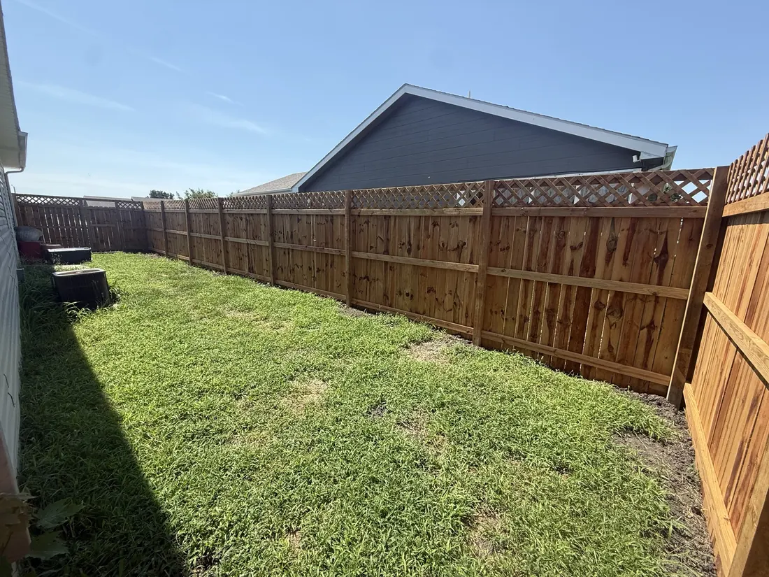 New cedar fence seen across a mown back yard