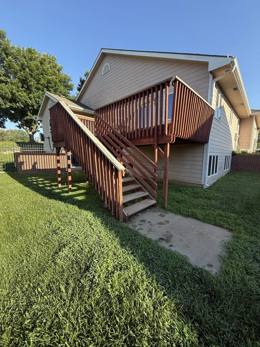 Resurfaced deck with new boards and restained railings seen from above