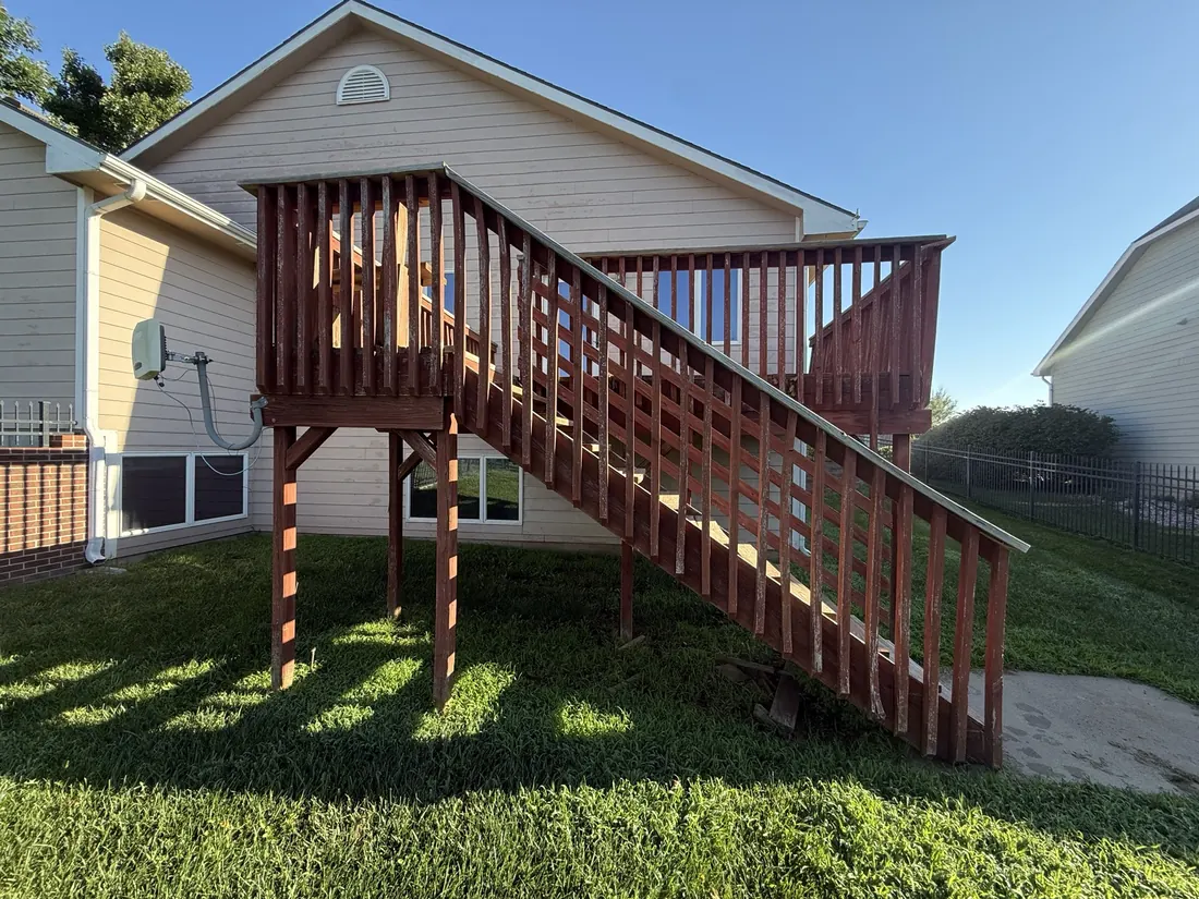 Weathered stained deck and stair run before the boards were replaced