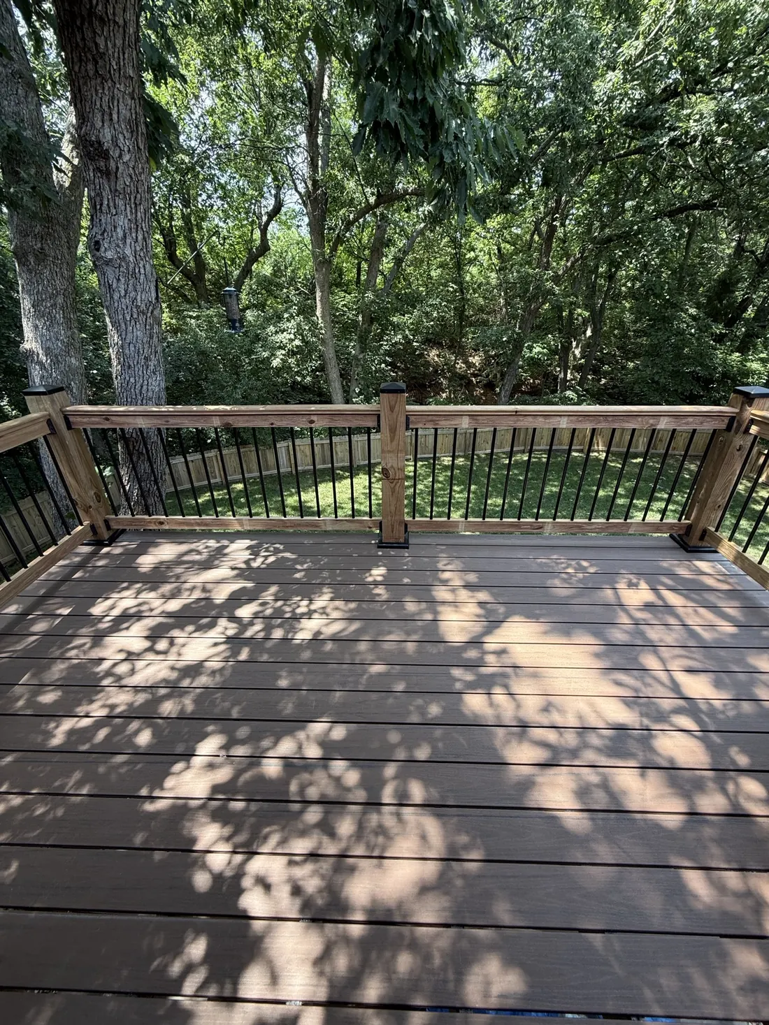 Deck boards after staining, run out under the tree canopy