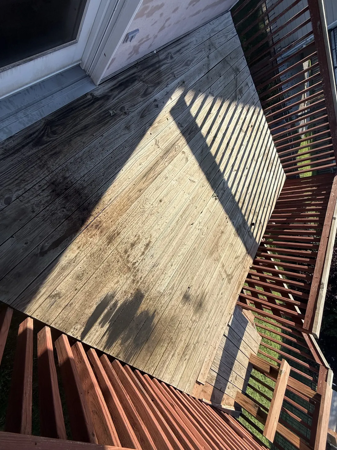 Corner of a resurfaced deck where the new boards meet the railing