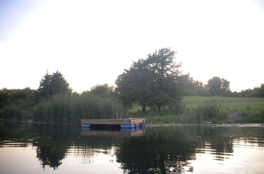 Floating dock and barrel floats on flat calm water
