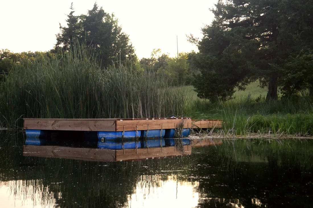 Finished floating dock sitting out on still water at a Kansas farm pond