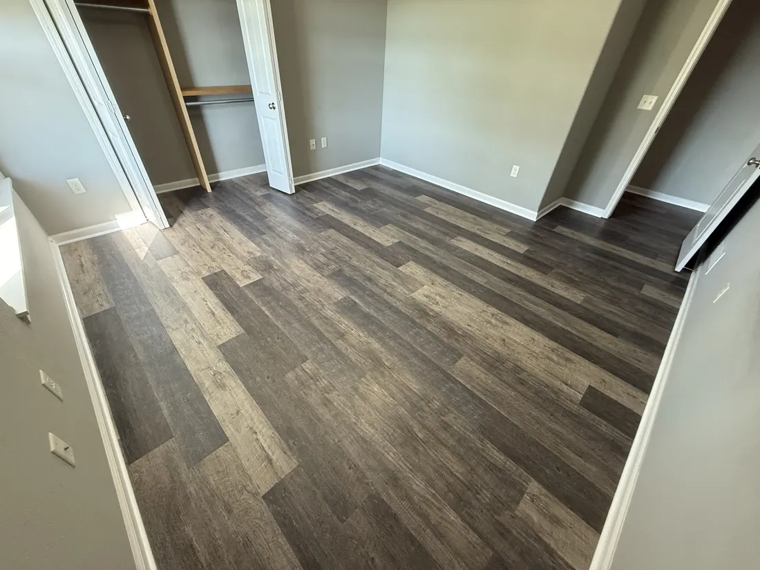 Plank flooring laid through a bedroom and its full closet run