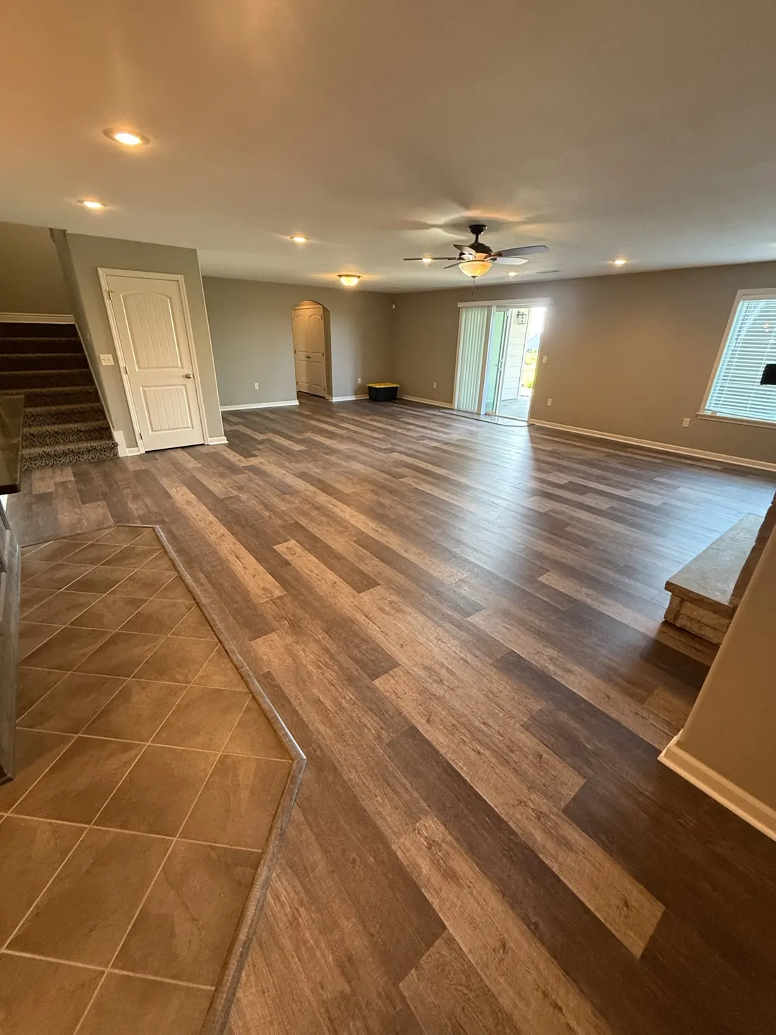 Plank flooring meeting the tiled entry in a clean straight join