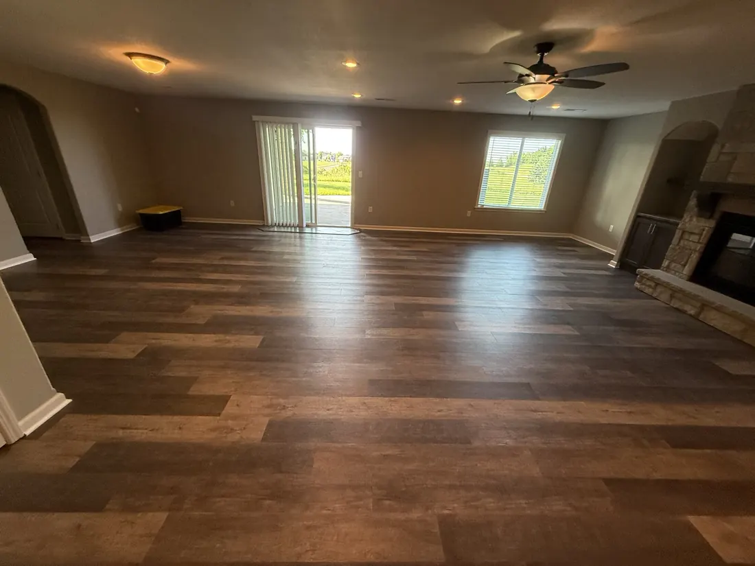 Open great room finished wall to wall in wide plank vinyl flooring