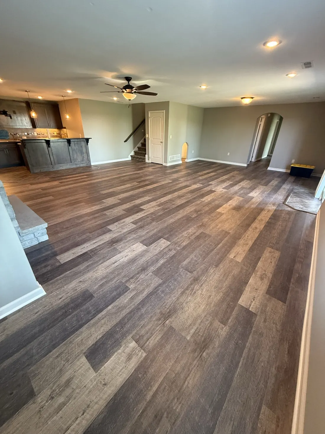 Plank flooring through a hall and landing under a ceiling fan