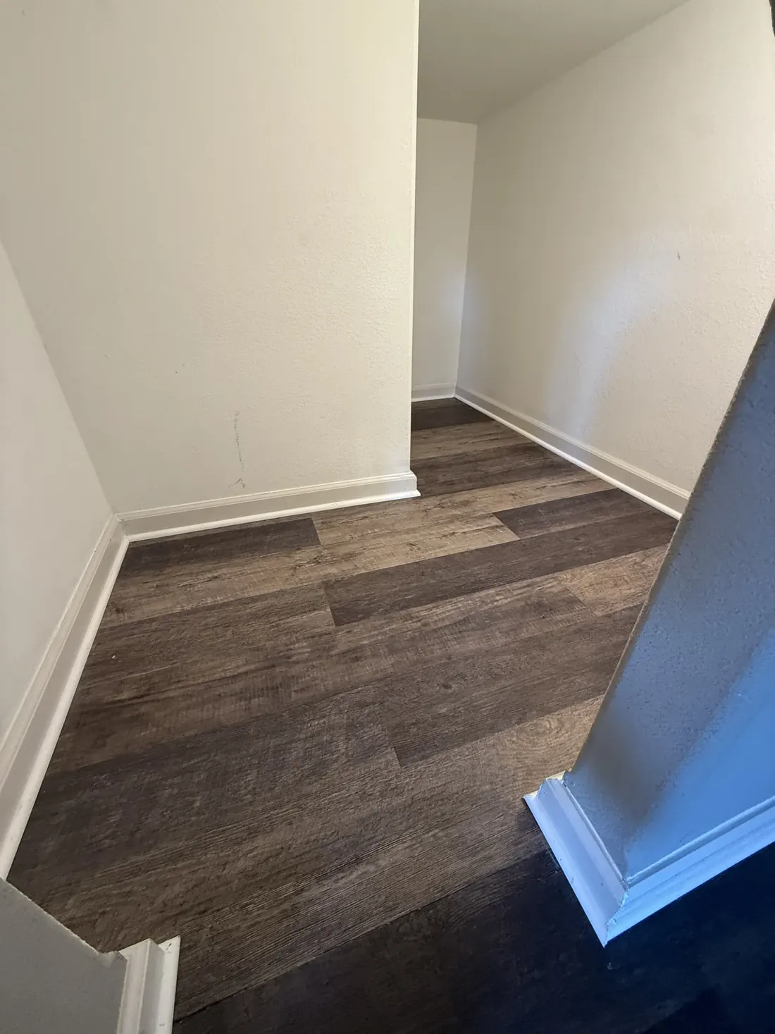 Plank flooring finished neatly at the top of a stair run