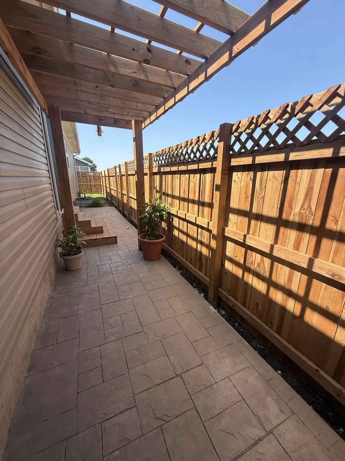 Cedar slats overhead on a finished pergola