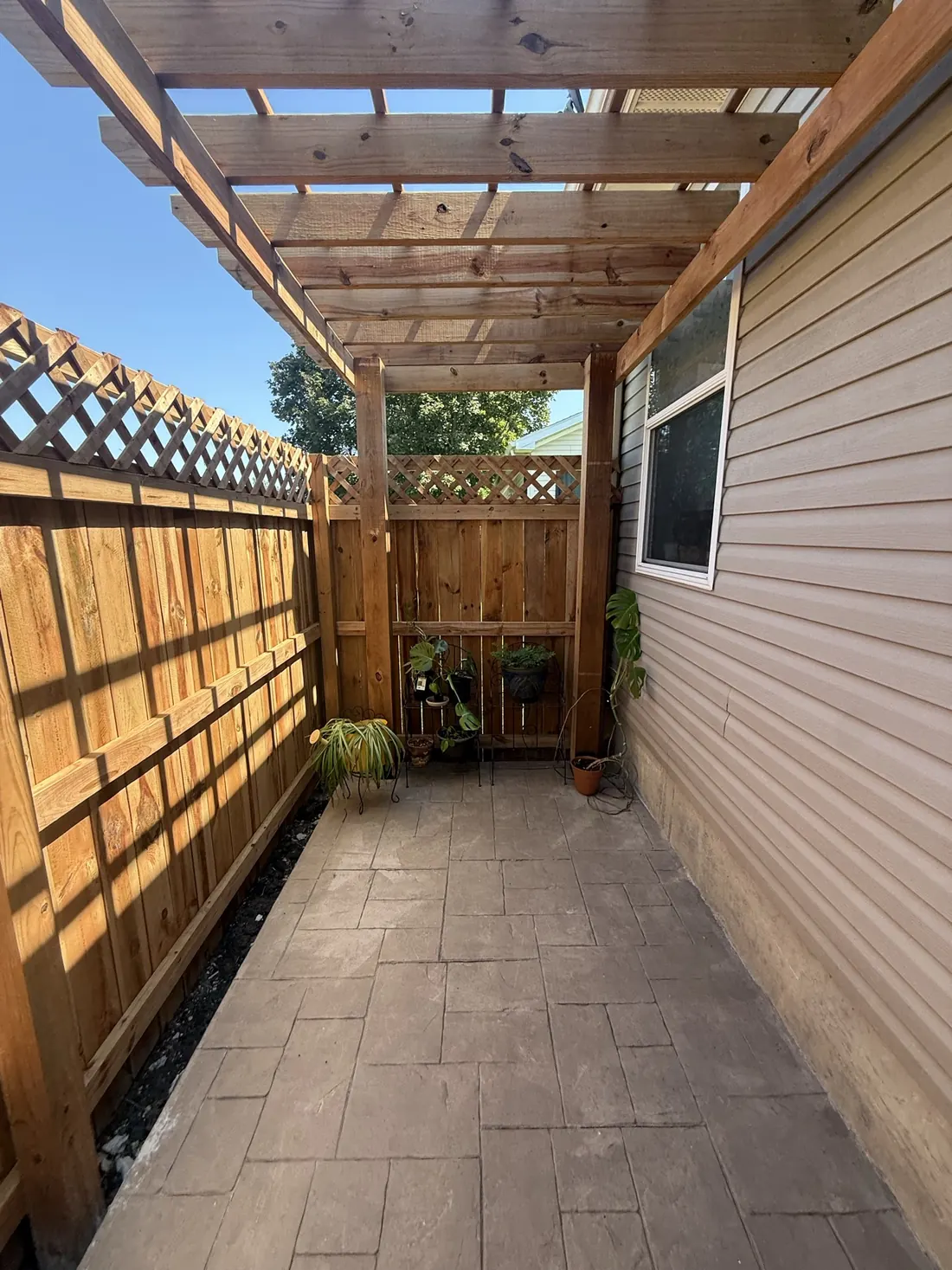 Cedar lattice screen running the length of a covered walkway