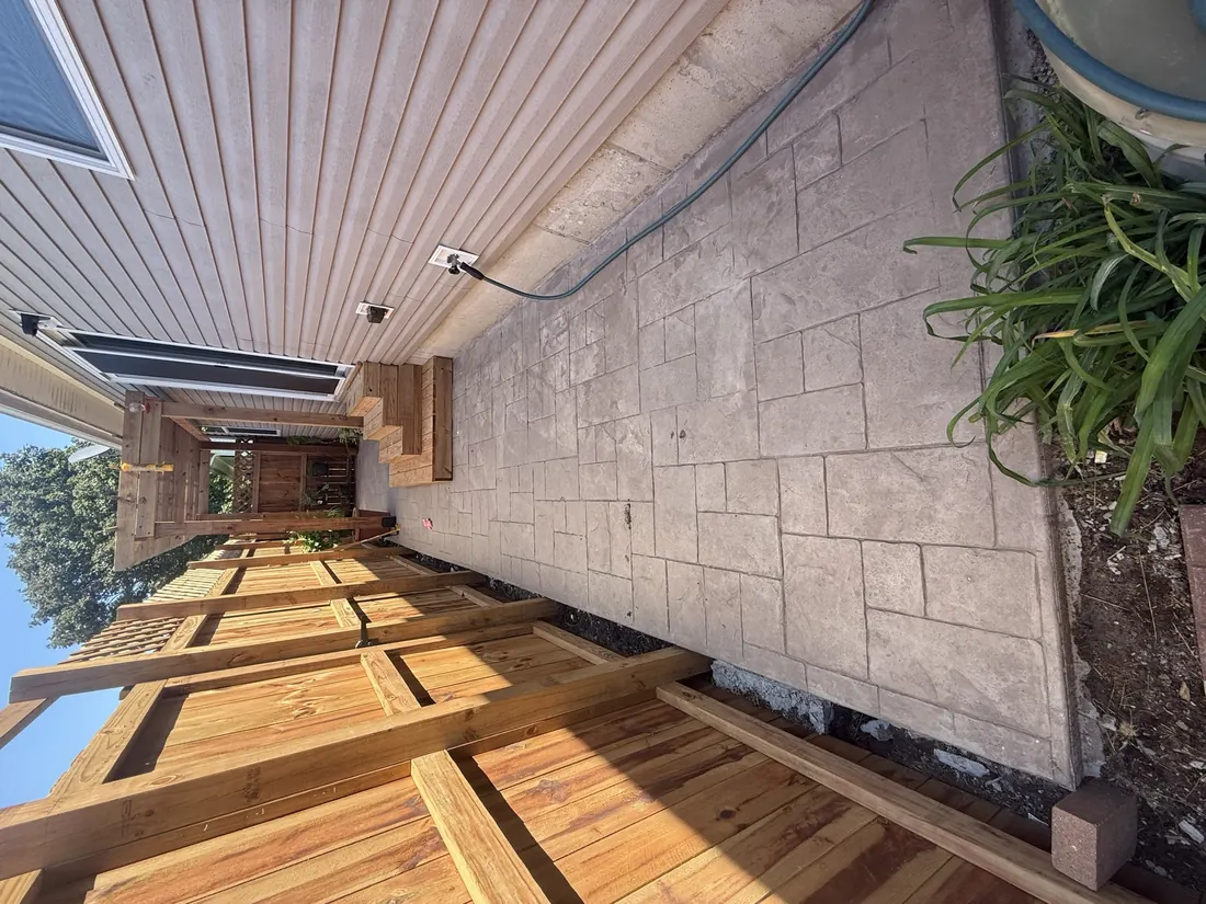 Cedar pergola and lattice screen over a stamped concrete walkway