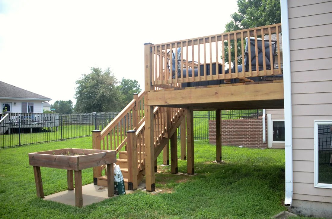 Built in cedar planter box beneath an elevated deck and stair landing