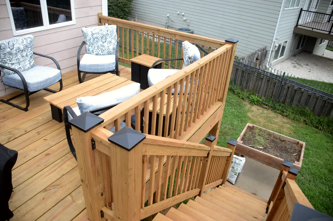 Seating area on a finished cedar deck with railings and a planter box