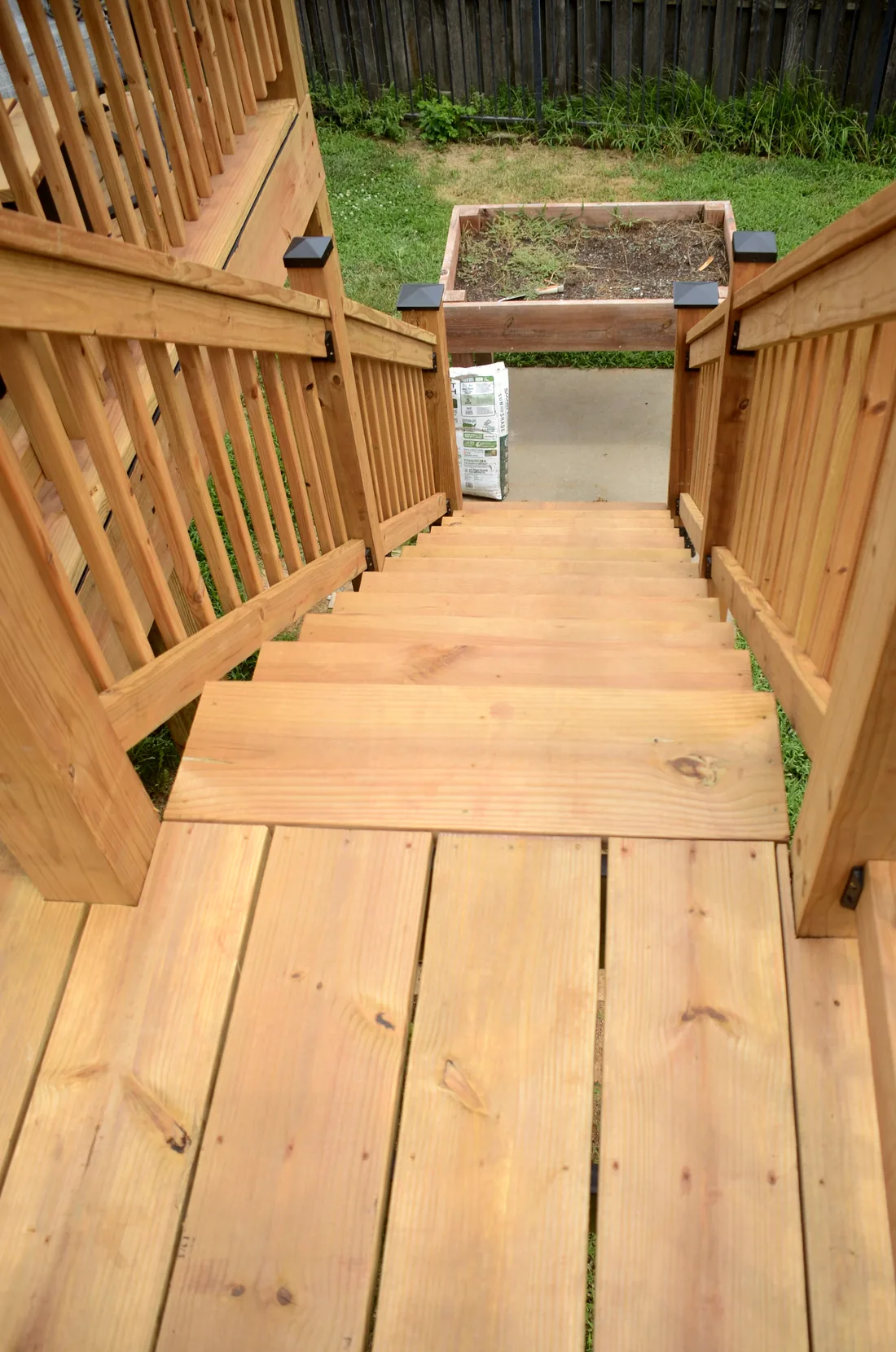 Cedar stair treads running down from a deck gate to the lawn