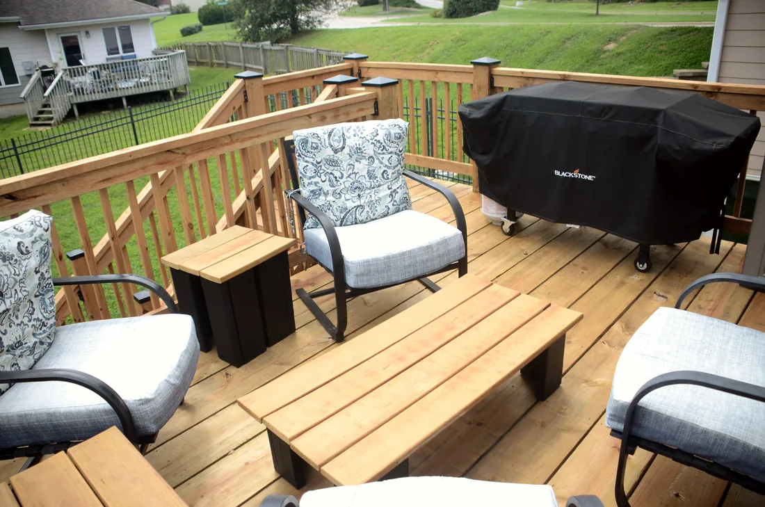 Cedar deck boards, railings and black post caps on a finished second story deck